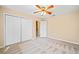 Neutral bedroom with light carpet, large closet, and ceiling fan at 444 Pineview Dr, Canton, GA 30114