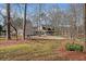 Landscaped front yard leading to a home with a three-car garage and welcoming porch at 444 Pineview Dr, Canton, GA 30114