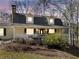 Charming home with a welcoming front porch, dormer windows, and mature trees in a wooded area at 444 Pineview Dr, Canton, GA 30114