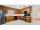 This kitchen has natural wood cabinets, stainless steel appliances, and tile backsplash at 444 Pineview Dr, Canton, GA 30114