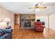 Open living room with hardwood floors, a stone fireplace, and built-in shelving at 444 Pineview Dr, Canton, GA 30114