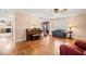 Bright living room with hardwood floors, a piano, and staircase with view to front entry at 444 Pineview Dr, Canton, GA 30114
