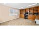 Spacious home office featuring a large built-in bookcase and a carpeted floor at 444 Pineview Dr, Canton, GA 30114