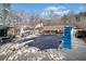 View of the pool area with slide, patio furniture, and well-maintained landscaping, for relaxation and entertainment at 444 Pineview Dr, Canton, GA 30114