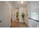 Neutral hallway featuring a plant and an open view of the house at 5060 Amber Leaf Dr, Roswell, GA 30076