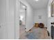 Bright hallway with linen closet leading to laundry area and light-filled living space at 54 Mildred Ct, Dallas, GA 30157