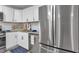 Well-lit kitchen featuring stainless steel appliances, white cabinets, granite countertops, and modern fixtures at 54 Mildred Ct, Dallas, GA 30157