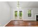Dining area featuring hardwood floors, access to backyard, and natural light from the window at 5745 River Ridge Ln, Sugar Hill, GA 30518