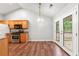 Dining area has hardwood floors, stainless steel appliances, and access to the backyard at 5745 River Ridge Ln, Sugar Hill, GA 30518
