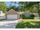 Charming brick home with attached garage, manicured lawn, and cute green shutters at 5745 River Ridge Ln, Sugar Hill, GA 30518