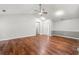 Bright living room with hardwood floors, ceiling fan, and neutral paint color scheme at 5745 River Ridge Ln, Sugar Hill, GA 30518