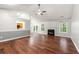 Spacious living room features hardwood floors, a fireplace, and plenty of natural light at 5745 River Ridge Ln, Sugar Hill, GA 30518