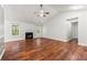 Light-filled living room with hardwood floors, fireplace, and views of the backyard at 5745 River Ridge Ln, Sugar Hill, GA 30518