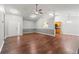 Open-concept living area boasts hardwood floors, neutral paint, and views to the kitchen at 5745 River Ridge Ln, Sugar Hill, GA 30518