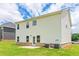 View of the home's rear exterior, featuring a well-maintained lawn and siding at 1587 Sungrown Way, Mcdonough, GA 30253