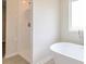 Bathroom featuring modern bathtub, a separate shower, and a window for natural light at 1587 Sungrown Way, Mcdonough, GA 30253