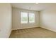 Bright bedroom featuring carpet, light walls and natural lighting at 1587 Sungrown Way, Mcdonough, GA 30253
