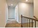 Upstairs hallway with carpet, white doors, and natural light at 1587 Sungrown Way, Mcdonough, GA 30253