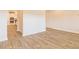 An open-concept floor plan has wood-look flooring and easy access to the kitchen at 1587 Sungrown Way, Mcdonough, GA 30253