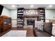 Cozy basement area with a stone fireplace, built-in bookshelves, and comfortable seating at 244 Sherbrook Nw Ct, Marietta, GA 30064