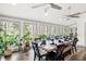 Beautiful dining area filled with plants, a long wooden table set for a meal, and natural light at 244 Sherbrook Nw Ct, Marietta, GA 30064