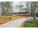 Exterior of home with front porch surrounded by trees and lush greenery along a winding driveway at 244 Sherbrook Nw Ct, Marietta, GA 30064