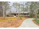 Ranch home with an inviting front porch nestled among towering trees, showcasing natural beauty at 244 Sherbrook Nw Ct, Marietta, GA 30064