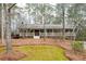 Charming ranch-style home with a welcoming front porch nestled among mature trees in a serene setting at 244 Sherbrook Nw Ct, Marietta, GA 30064