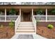 Inviting front porch with stairs, potted plants, and a welcome mat leading to the front door at 244 Sherbrook Nw Ct, Marietta, GA 30064