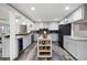 Well-designed kitchen with a wine cooler, modern appliances, and an island with wine storage at 244 Sherbrook Nw Ct, Marietta, GA 30064