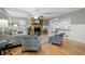 Cozy living room with hardwood floors, stone fireplace, and a view of an open kitchen and sunroom at 244 Sherbrook Nw Ct, Marietta, GA 30064