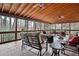 Spacious screened porch with wood ceiling, ceiling fans, and comfortable seating area at 244 Sherbrook Nw Ct, Marietta, GA 30064
