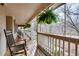 A large, covered porch with rocking chairs and plants, creating a relaxing outdoor living space at 244 Sherbrook Nw Ct, Marietta, GA 30064