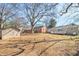 Large backyard with mature trees, storage shed, partial fence and a rear home view at 2716 Wedgewood Ter, Decatur, GA 30032