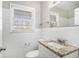 Bright bathroom features white tile, granite vanity, and a window with natural light at 2716 Wedgewood Ter, Decatur, GA 30032