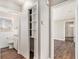 Hallway with wood floors featuring closet storage and views to bathroom and entry area at 2716 Wedgewood Ter, Decatur, GA 30032