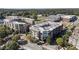 Aerial view of multi-story buildings with roof top decks, surrounding trees, and street at 58 Canton St # 302, Alpharetta, GA 30009