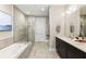 Luxurious bathroom with a soaking tub, glass shower, double vanity, and contemporary finishes at 58 Canton St # 302, Alpharetta, GA 30009