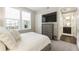 Comfortable bedroom featuring a dresser, TV, and an adjacent bathroom at 58 Canton St # 302, Alpharetta, GA 30009