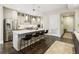 Bright kitchen with stainless steel appliances, an island with seating, and hardwood floors at 58 Canton St # 302, Alpharetta, GA 30009