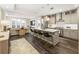 Open-concept kitchen with stainless steel appliances, island with seating, and hardwood floors flows to the living room at 58 Canton St # 302, Alpharetta, GA 30009