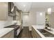 A kitchen with stainless steel appliances, an island with seating, and marble backsplash at 58 Canton St # 302, Alpharetta, GA 30009