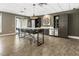 Entertaining kitchen features counter seating, cabinets, sink, mini fridge, and elegant pendant lighting at 58 Canton St # 302, Alpharetta, GA 30009