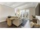 Well-lit living room with modern decor, dark hardwood floors, recessed ceiling lights, and large glass doors to a balcony at 58 Canton St # 302, Alpharetta, GA 30009