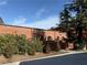 Charming brick building exterior with unique arched windows, landscaped shrubs, and wood railings at 184 Sw Walker Street # E, Atlanta, GA 30313
