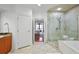 Bright bathroom with marble floors, double vanity, soaking tub, and glass walk-in shower at 3286 Northside Nw Pkwy # 304, Atlanta, GA 30327