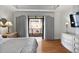 Bright bedroom with hardwood floors, natural light, and a walkout balcony at 3286 Northside Nw Pkwy # 304, Atlanta, GA 30327