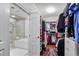 Organized walk-in closet with shelving and hanging space, next to the primary bath featuring a tub and separate shower at 3286 Northside Nw Pkwy # 304, Atlanta, GA 30327