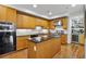 Modern kitchen with stainless steel appliances, granite countertops and island with hardwood floor at 3286 Northside Nw Pkwy # 304, Atlanta, GA 30327