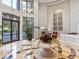 Grand lobby features marble floors, soaring ceilings, and a round table display with plants at 3286 Northside Nw Pkwy # 304, Atlanta, GA 30327